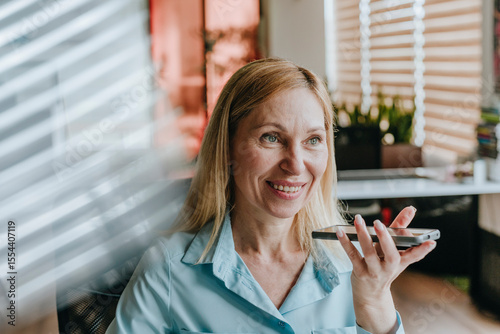 Businesswoman in office using phone for communication