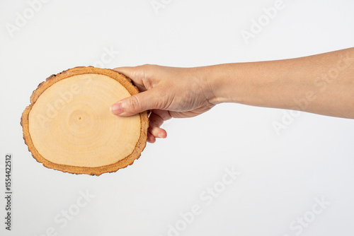Wooden coaster for drinking water or props for taking photos in hand with a white background