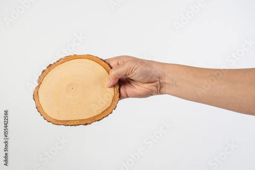 Wooden coaster for drinking water or props for taking photos in hand with a white background
