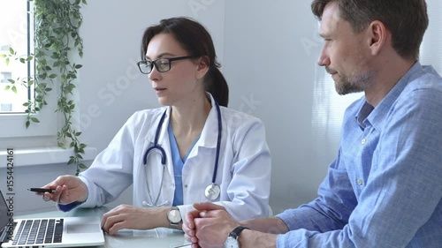 Female doctor explaining a diagnosis to a male patient, offering medical advice and support during a consultation in her office, fostering communication and trust. Medicine and health care