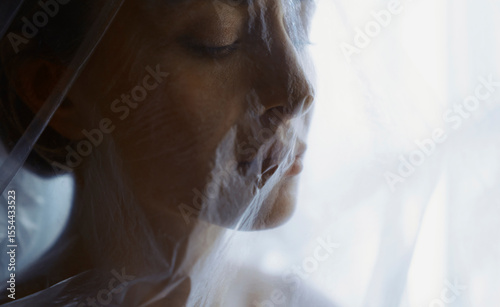 Woman wrapped in plastic sheet symbolizing anxiety and environmental issues