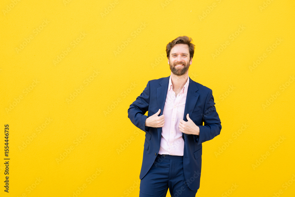 Confident businessman smiling at camera against yellow background Confident businessman smiling at camera against yellow background