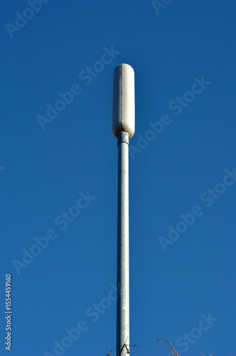 Isolated Cell Phone Network Mast seen against Blue Sky 