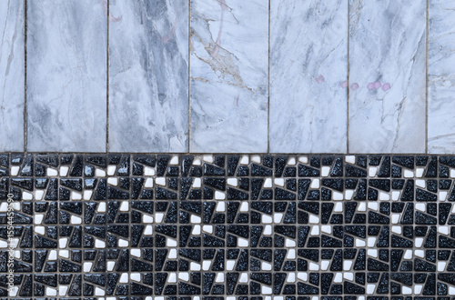 Wall with Ceramic Tiles with Pattern and Marbled Effect in Close Up 