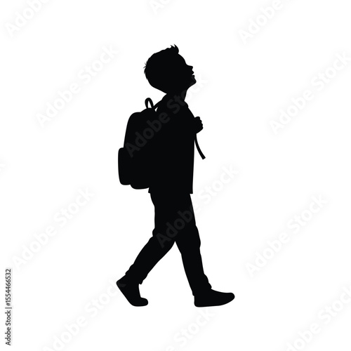 Silhouette of a boy walking to school with a backpack looking up