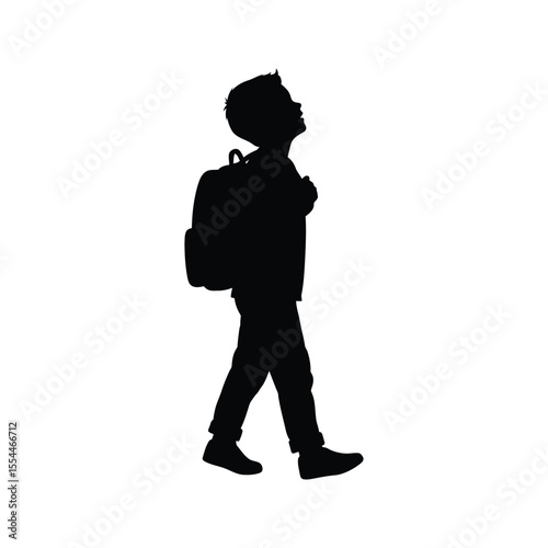 Silhouette of a boy walking to school with a backpack looking up