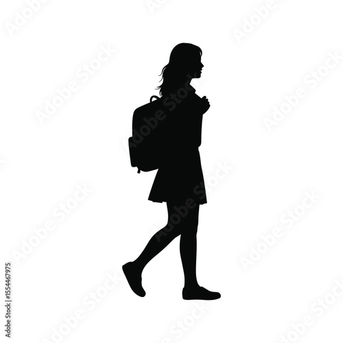 Silhouette of a girl student walking to school with a backpack