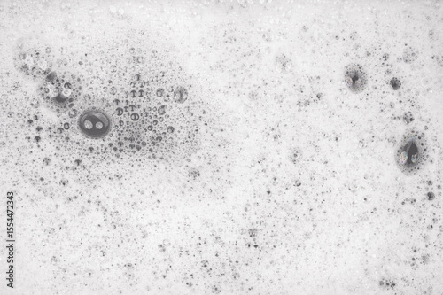 White pure foam in water background texture. dishwashing foam close up