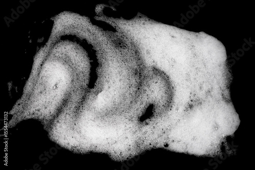 White pure foam on black background. dishwashing foam isolated dark background