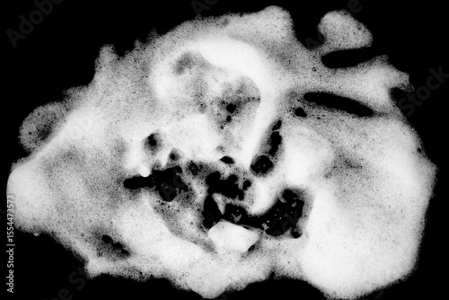 White pure foam on black background. dishwashing foam isolated dark background