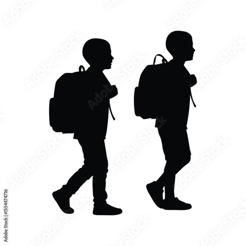 Silhouette of two school children walking with backpacks back to school kids education