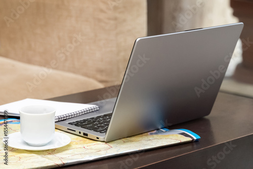 Freelance education focused on online geography with a laptop and coffee setup
