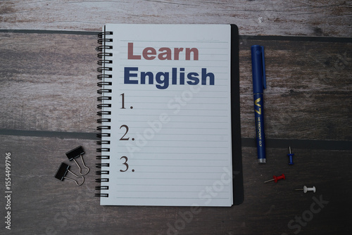 English words learning education concept lettering posters writing notebook brown wooden background