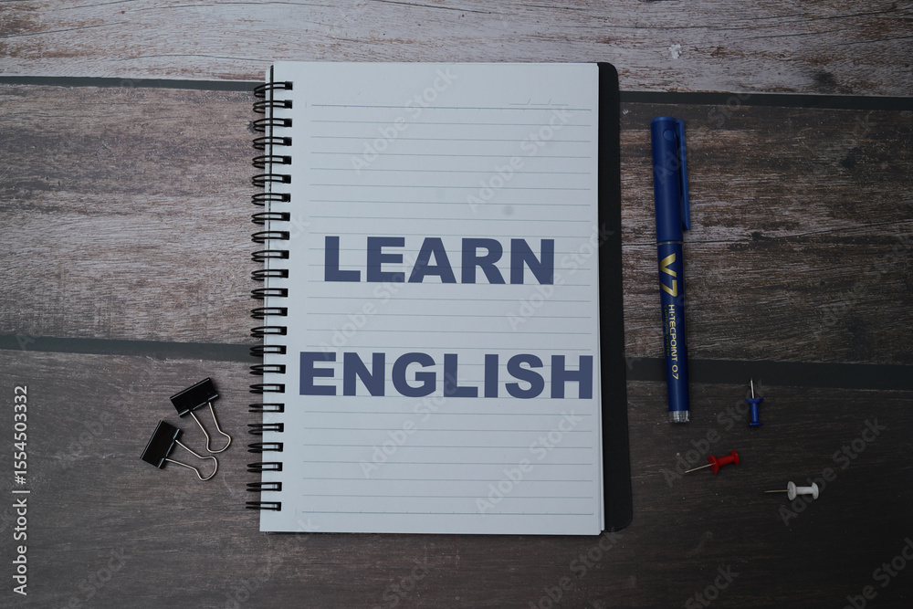 English words learning education concept lettering posters writing notebook brown wooden background English words learning education concept lettering posters writing notebook brown wooden background