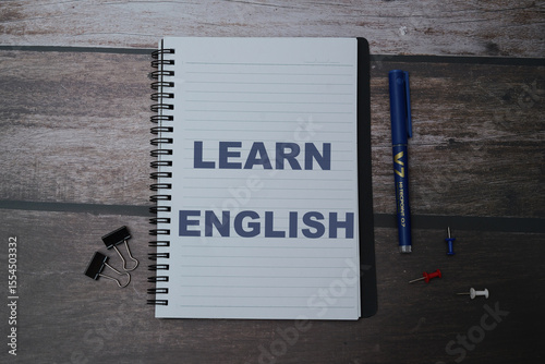 English words learning education concept lettering posters writing notebook brown wooden background