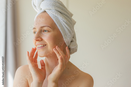 Wallpaper Mural Cheerful young woman wrapped in a white towel smiling with eyes closed, enjoying a peaceful self-care moment at home. Natural beauty, relaxation, and skincare routine concept. Torontodigital.ca