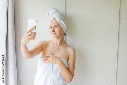 Wallpaper Mural Young woman relaxing at home with a hydrating facial sheet mask.  kincare routine, beauty treatment, and wellness lifestyle concept. Torontodigital.ca