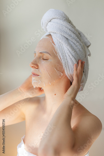 Wallpaper Mural Young woman relaxing at home with a hydrating facial sheet mask.  kincare routine, beauty treatment, and wellness lifestyle concept. Torontodigital.ca