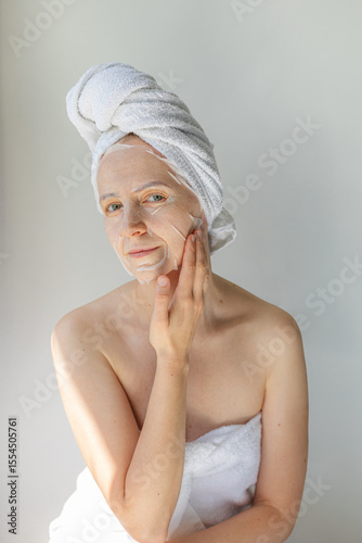 Wallpaper Mural Young woman relaxing at home with a hydrating facial sheet mask.  kincare routine, beauty treatment, and wellness lifestyle concept. Torontodigital.ca