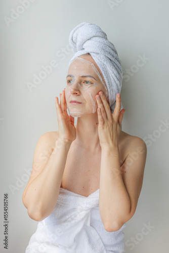 Wallpaper Mural Young woman relaxing at home with a hydrating facial sheet mask.  kincare routine, beauty treatment, and wellness lifestyle concept. Torontodigital.ca