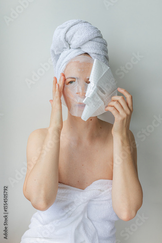Wallpaper Mural Young woman relaxing at home with a hydrating facial sheet mask.  kincare routine, beauty treatment, and wellness lifestyle concept. Torontodigital.ca
