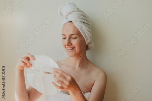 Wallpaper Mural Young woman relaxing at home with a hydrating facial sheet mask.  kincare routine, beauty treatment, and wellness lifestyle concept. Torontodigital.ca