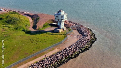 Aerial video of the old Seaforth radar Tower next to the sea defence and river Mersey in Liverpool UK. 