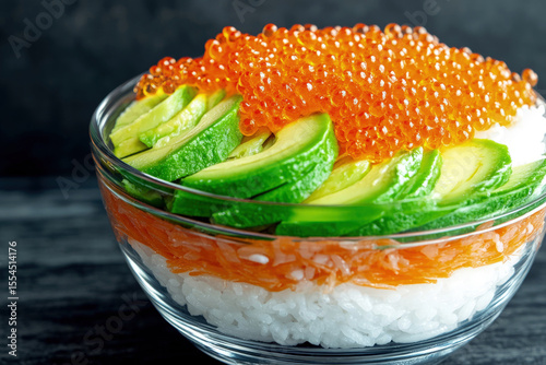 Fresh Sushi Bowl with Rice Fish Roe and Sliced Avocado in Glass