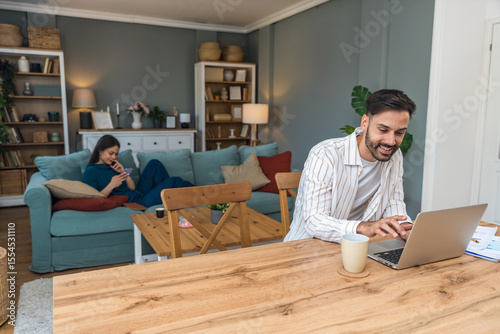 Finance and economy. Young man, small business owner, working online at home office, preparing for video call for presentation and online coaching. E-commerce professional occupation freelance work