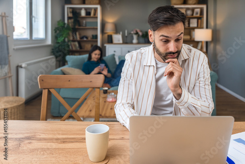 Finance and economy. Young man, small business owner, working online at home office, preparing for video call for presentation and online coaching. E-commerce professional occupation freelance work