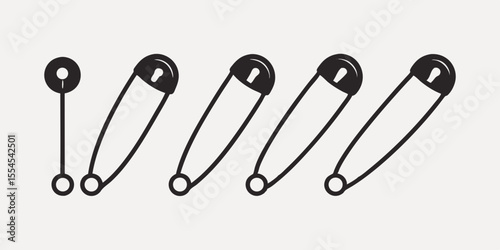 A row of black safety pins and a single pin isolated on white background