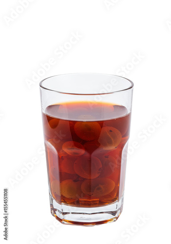 Wallpaper Mural A glass cup filled with dark juice and floating fruits against a black background Torontodigital.ca