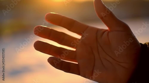 Relaxed Hand with Rising Vapor at Sunset