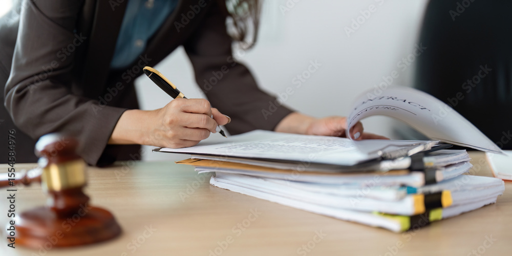 Fototapeta premium Legal Documentation. Lawyer reviewing contracts with gavel on desk.
