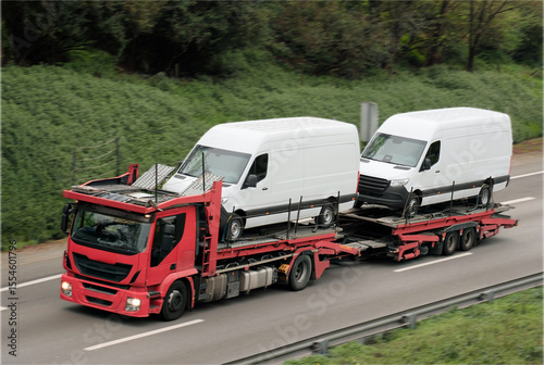 Wallpaper Mural Red Car Carrier Transporting Two White Cargo Vans on Highway Torontodigital.ca