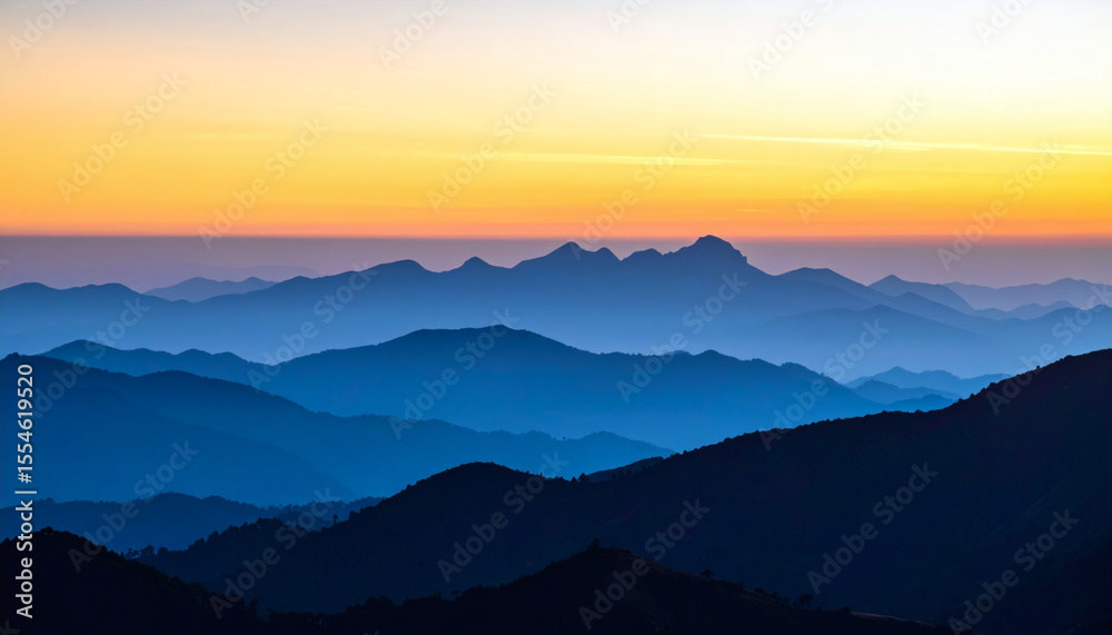 Obraz premium Serene Sunrise Over Majestic Mountain Range with Soft Color Palette