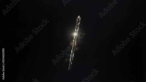 Floating magician’s wand with magic dust, isolated in black background