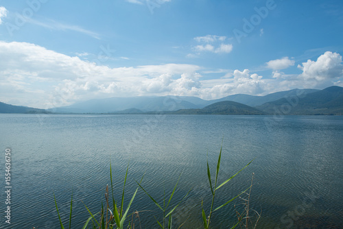 Fototapeta Naklejka Na Ścianę i Meble -  Spectacular Bafa Lake view in sunny and cloudy weather. Reflections in Bafa Lake. View of Bafa Lake Nature Park in Türkiye.