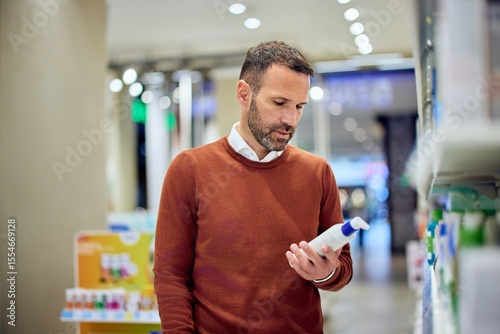 Man Shopping for Personal Care Products in a Well-Lit Retail Store