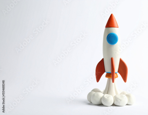 A colorful clay rocket taking off on a white background. Perfect for space, science, or children's themes.