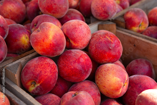 Close-up of fresh ripe red summer peaches at a local farmer's market