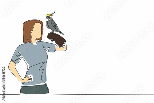 Single one line drawing grey cockatiel perched on hand of woman. Bird with characteristic crest on its head. A gentle and loving animal. Woman Holding Bird. Continuous line design graphic illustration
