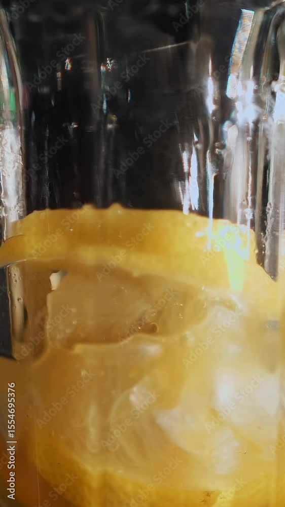Cocktail. Bartender makes cocktail. close-up. Bartender crushes mint leaves and slices of orange in a glass, on a black background. Cocktail. Bartender makes cocktail. close-up. Bartender crushes mint leaves and slices of orange in a glass, on a black background.