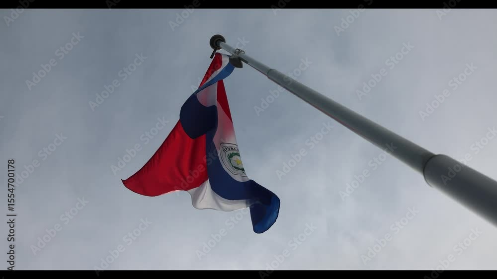 The National Flag of Paraguay flutters in the wind. Great for news. Close-up. The flag of Paraguay against the blue sky. 4K video.
