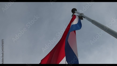 The National Flag of Paraguay flutters in the wind. Great for news. Close-up. The flag of Paraguay against the blue sky. 4K video.