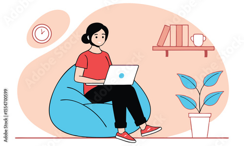 A young woman with dark hair tied in a bun wearing a red t shirt and black pants is comfortably working on her laptop while sitting on a large blue beanbag chair in a cozy room