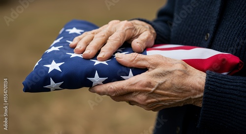 Holding Folded National Flag in Hands Displaying Patriotism and Respect