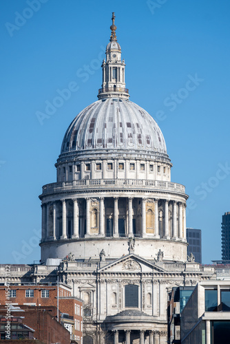 The magnificent dome of St. Paul's Cathedral rises majestically against a clear blue sky. This iconic landmark showcases London's rich architectural history and attracts many visitors daily.