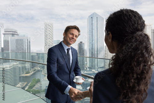 Business handshake with a view of city skyline