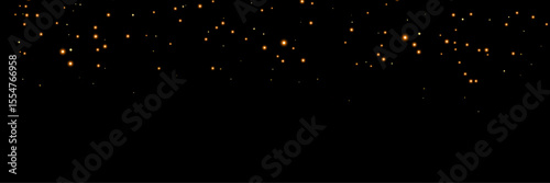 falling light particles. Festive golden bokeh and dust particles shimmering in the air, gold lights and dark background